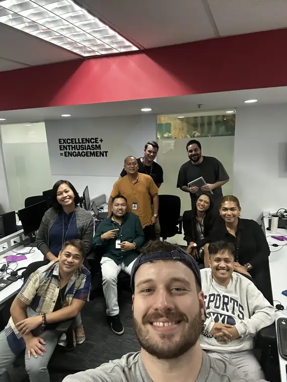 A selfie with a group of smiling colleagues in a contact centre